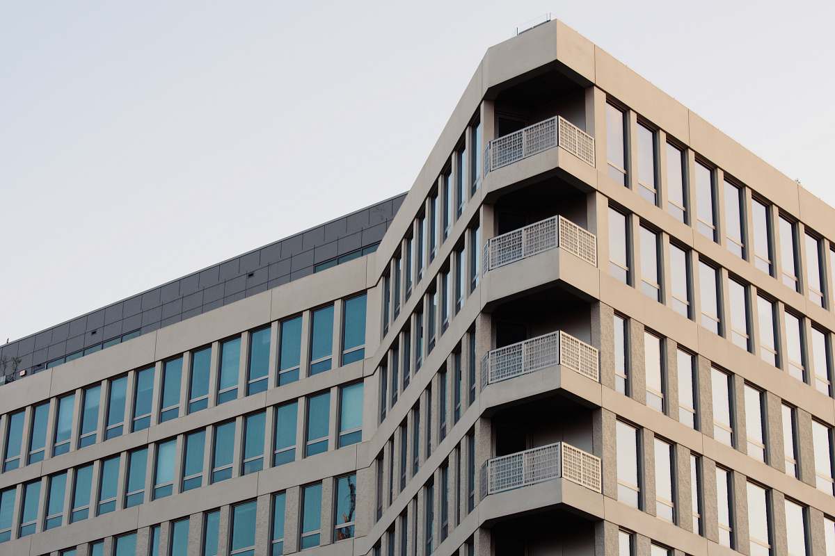office building beige building with glass windows city